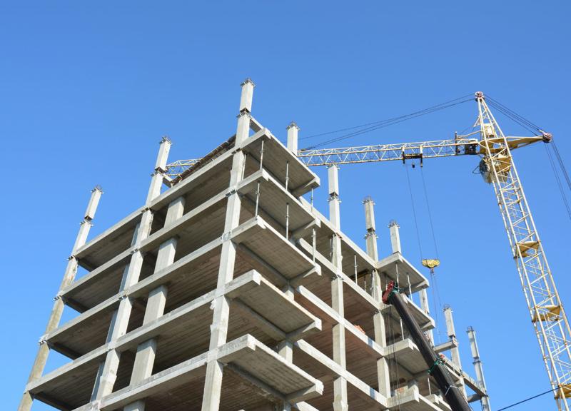 building under construction and crane