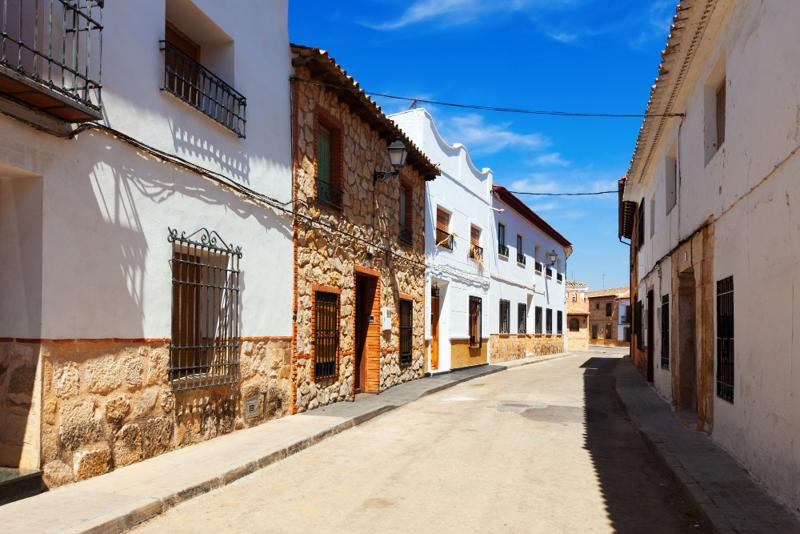 Traditional whitewashed Spanish residential street, representing the resale housing market