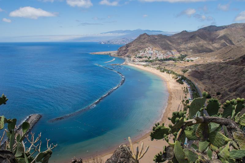 Elevated view of the curved golden sand beach of Las Teresitas and the coastal village of San Andres near Santa Cruz de Tenerife.