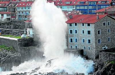Village evacuated and waves destroy port as freak wind and rain sweeps the western half of Spain