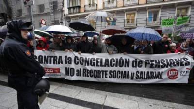 Pensioners brave downpours to protest outside treasury